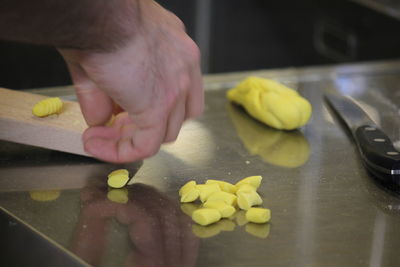 Midsection of person preparing food in kitchen at home