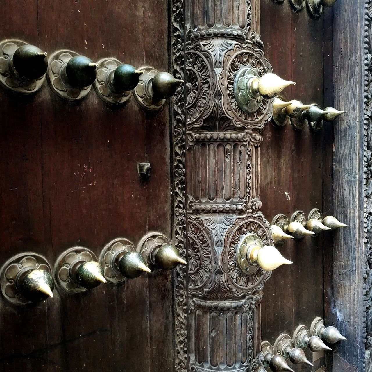 CLOSE-UP OF DOOR KNOCKER ON WOODEN TABLE