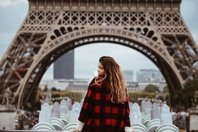 Rear view of woman standing on bridge