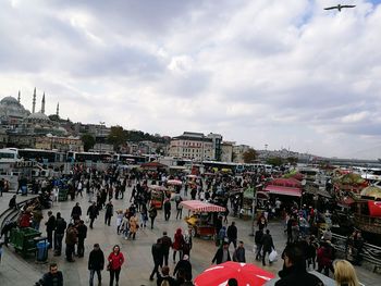 Crowd at town square against sky
