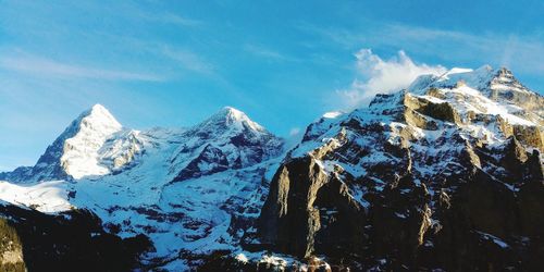 View of snowcapped mountain against cloudy sky