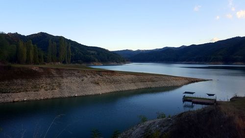 Scenic view of lake against clear blue sky