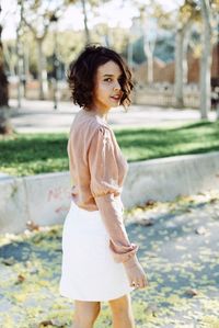 Side view of woman standing in park