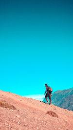 Man standing against blue sky