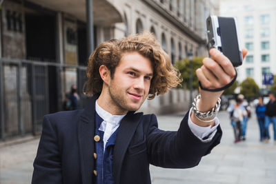 Portrait of young man photographing