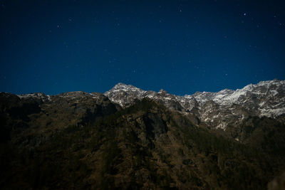 Scenic view of mountains against clear sky at night