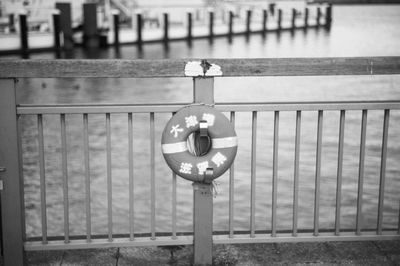 Close-up of electric lamp hanging on railing