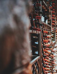 Close-up of wine bottles on shelves in store