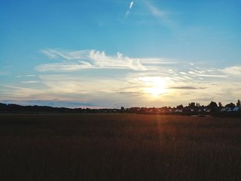 Scenic view of field against sky during sunset