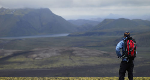 Man with rucksack overlooking the icelandic highlands