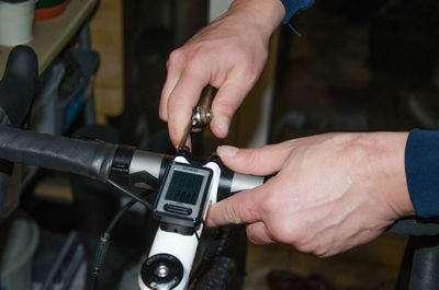 Cropped image of hands repairing bicycle