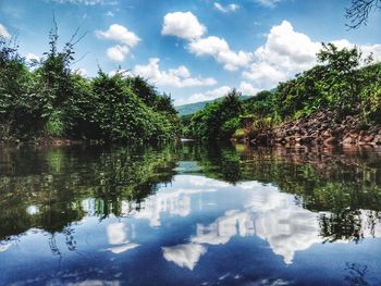 Reflection of trees in lake against sky