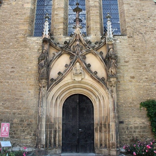 architecture, building exterior, built structure, church, religion, place of worship, arch, spirituality, low angle view, cathedral, old, history, window, facade, entrance, day, building, city