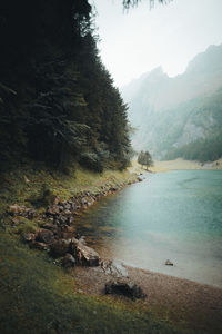 Scenic view of lake and mountains against sky