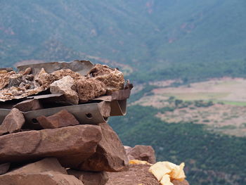 Stack of rocks on field against mountain