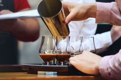 Midsection of barista preparing food in kitchen