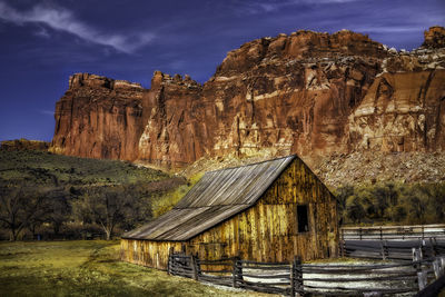 Built structure on rock against sky