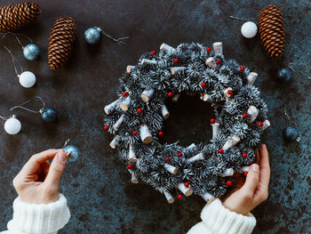 Cropped hands of woman holding christmas decoration