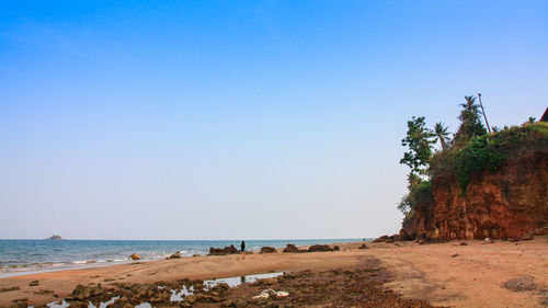 Scenic view of beach against clear blue sky