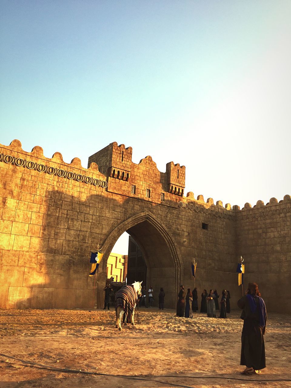 architecture, built structure, building exterior, clear sky, men, copy space, lifestyles, history, leisure activity, person, arch, travel, old, tourist, old ruin, travel destinations, the past, tourism, ancient