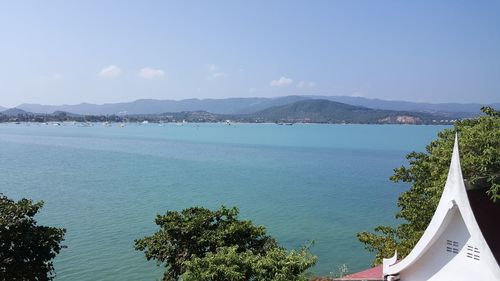 Calm sea with mountain range in background