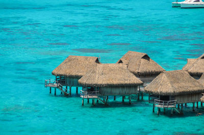 Houses by sea against blue sky