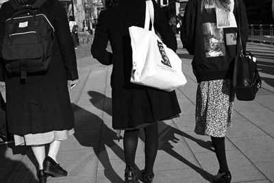 Low section of people walking on street