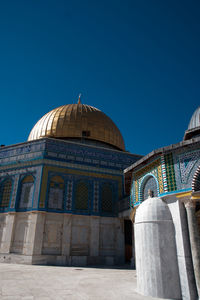 Low angle view of a building against blue sky