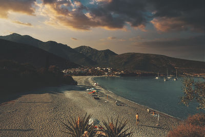 High angle view of townscape by sea against sky during sunset