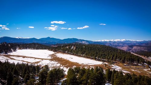 Scenic view of mountains against blue sky