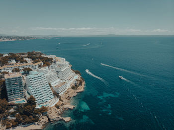 High angle view of buildings by sea against sky