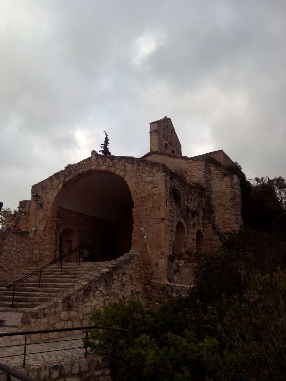 architecture, built structure, building exterior, sky, low angle view, place of worship, history, religion, old, cloud - sky, spirituality, church, arch, the past, ancient, old ruin, cloud, cloudy