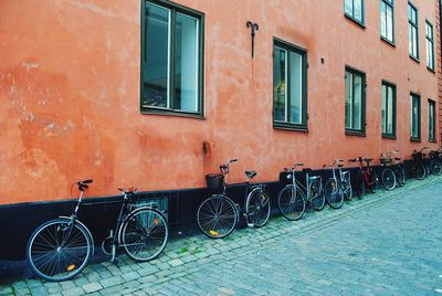 Bicycles parked on street against building