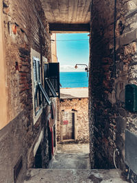 Alley amidst buildings against sky
