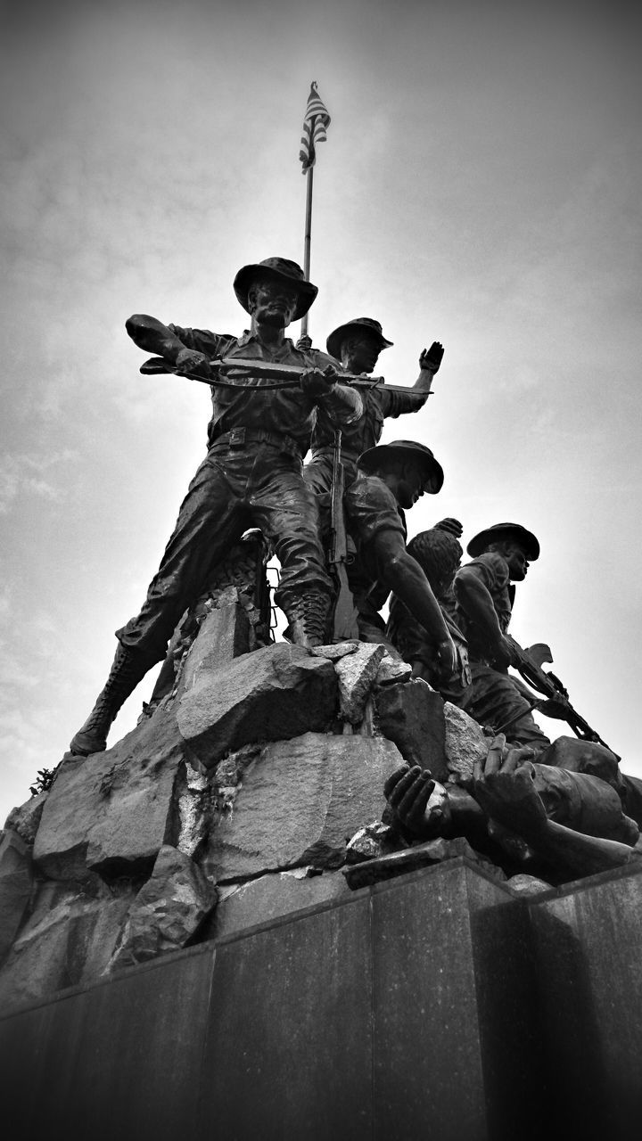 statue, low angle view, sculpture, human representation, art, art and craft, creativity, sky, clear sky, outdoors, built structure, no people, religion, cross, old, day, monument, architecture