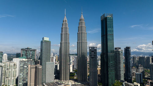 Skyscrapers in city against clear blue sky