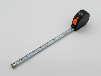 Close-up of tape measure on white background