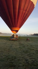 View of hot air balloon flying over land