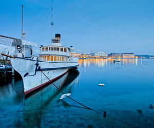 Boat moored in river against built structures