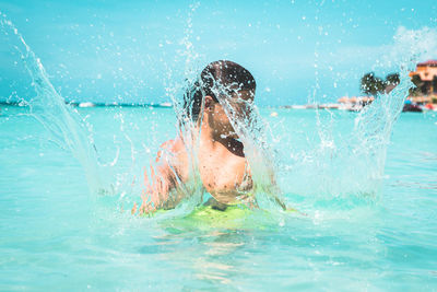 Girl swimming in pool during summer