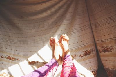 Low section of woman relaxing in hammock