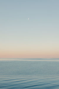 Scenic view of sea against clear sky during sunset