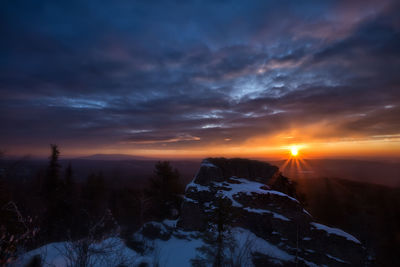 Scenic view of snowcapped mountains against sky during sunset