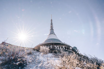 Low angle view of communications tower against sky