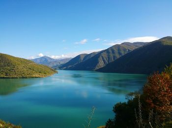 Scenic view of lake with mountains in background