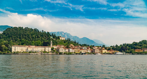 View of townscape by sea against sky