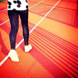 Low section of woman standing on tiled floor