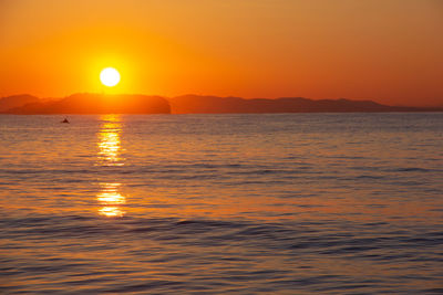 Scenic view of sea against romantic sky at sunset