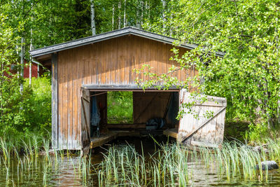 Built structure in lake amidst trees in forest