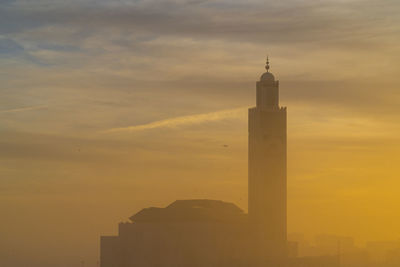 Low angle view of building against sky during sunset